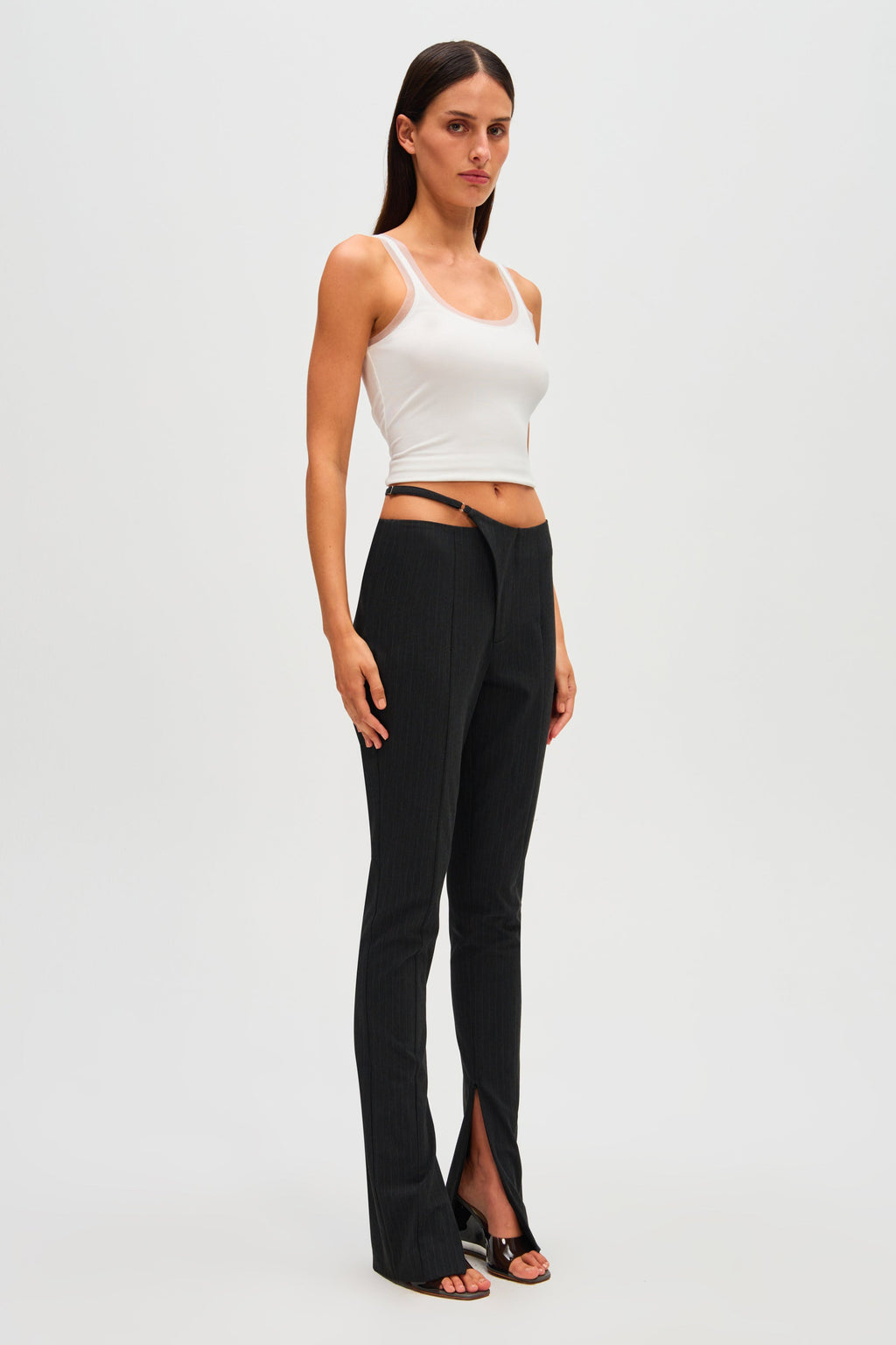 Black pinstripe high-waist pants with straight legs and front slit