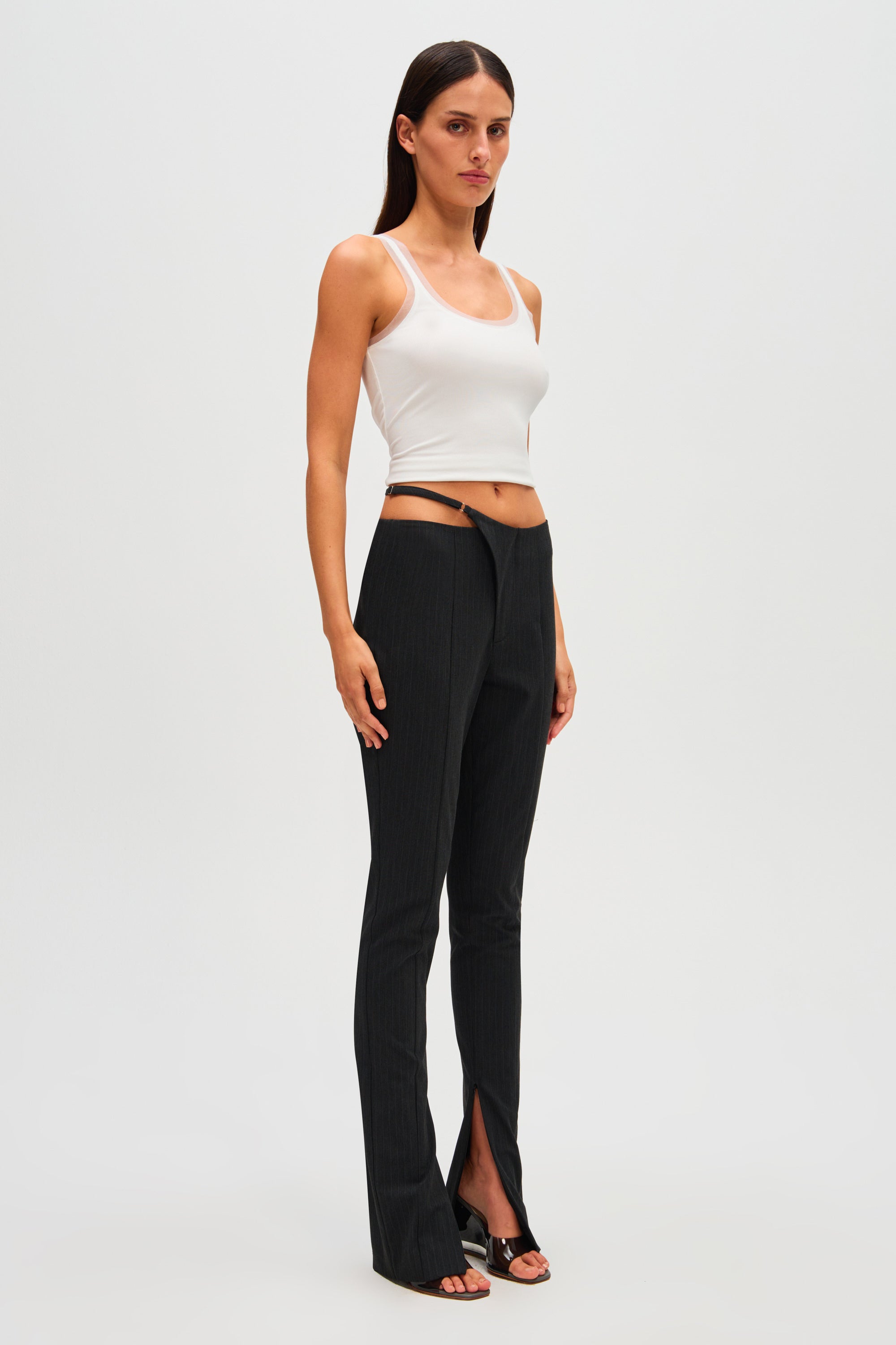 Black pinstripe high-waist pants with straight legs and front slit