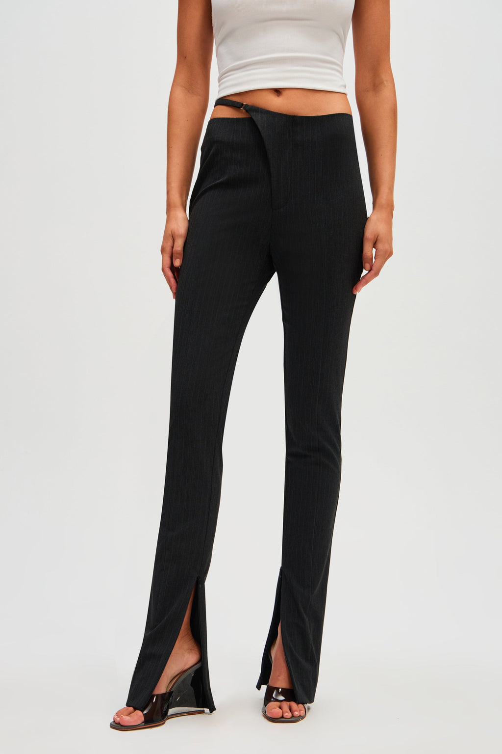 Black pinstripe high-waist pants with center seam and front leg slit