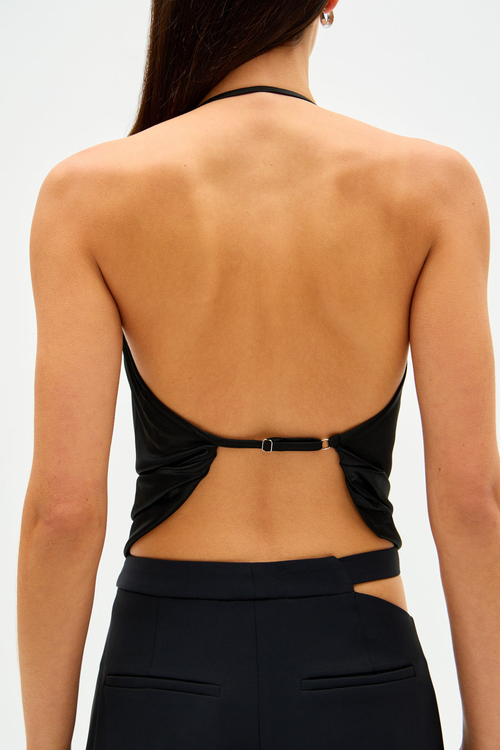Black backless jersey camisole top with V-cut back and center strap