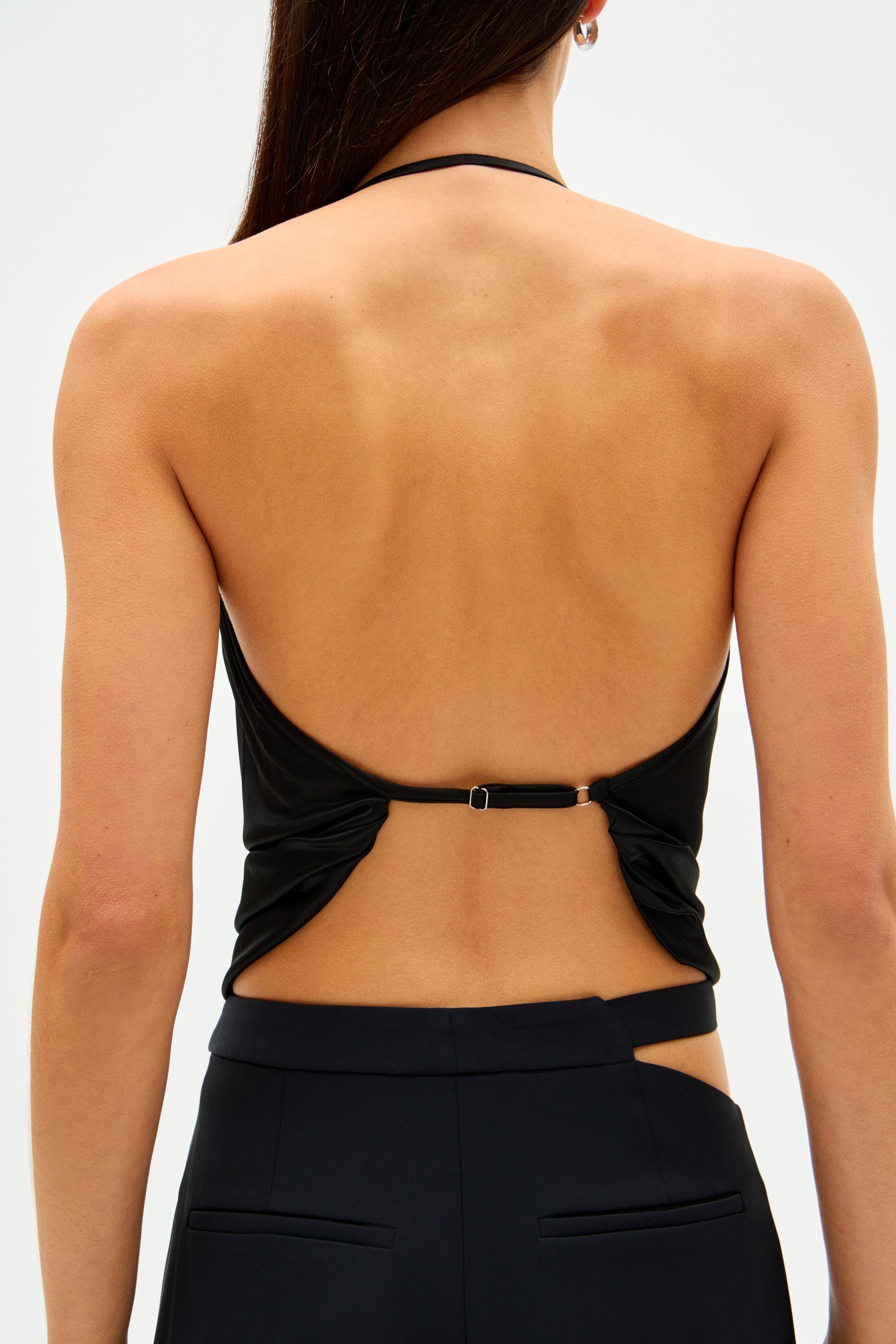 Black backless jersey camisole top with V-cut back and center strap