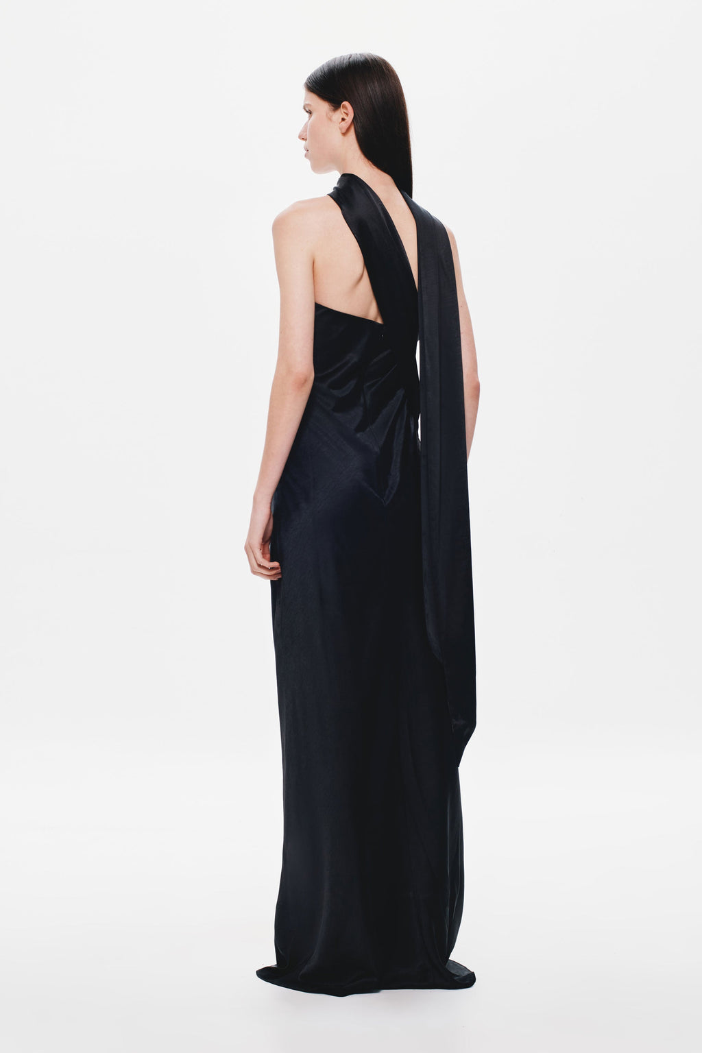 Black satin open-back maxi dress with halter strap drape over shoulders