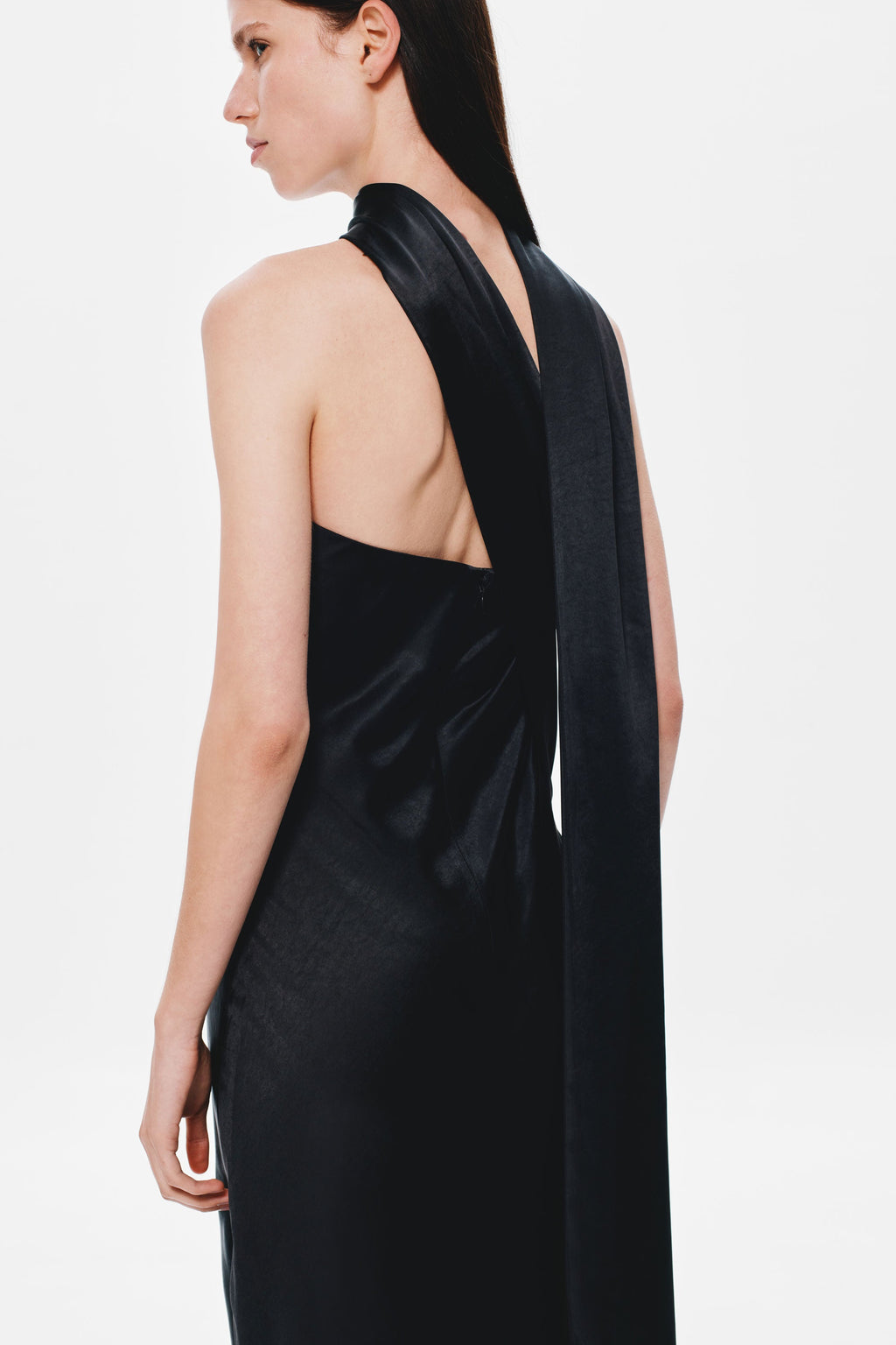 Black satin halter-back dress with open back and draped strap detail