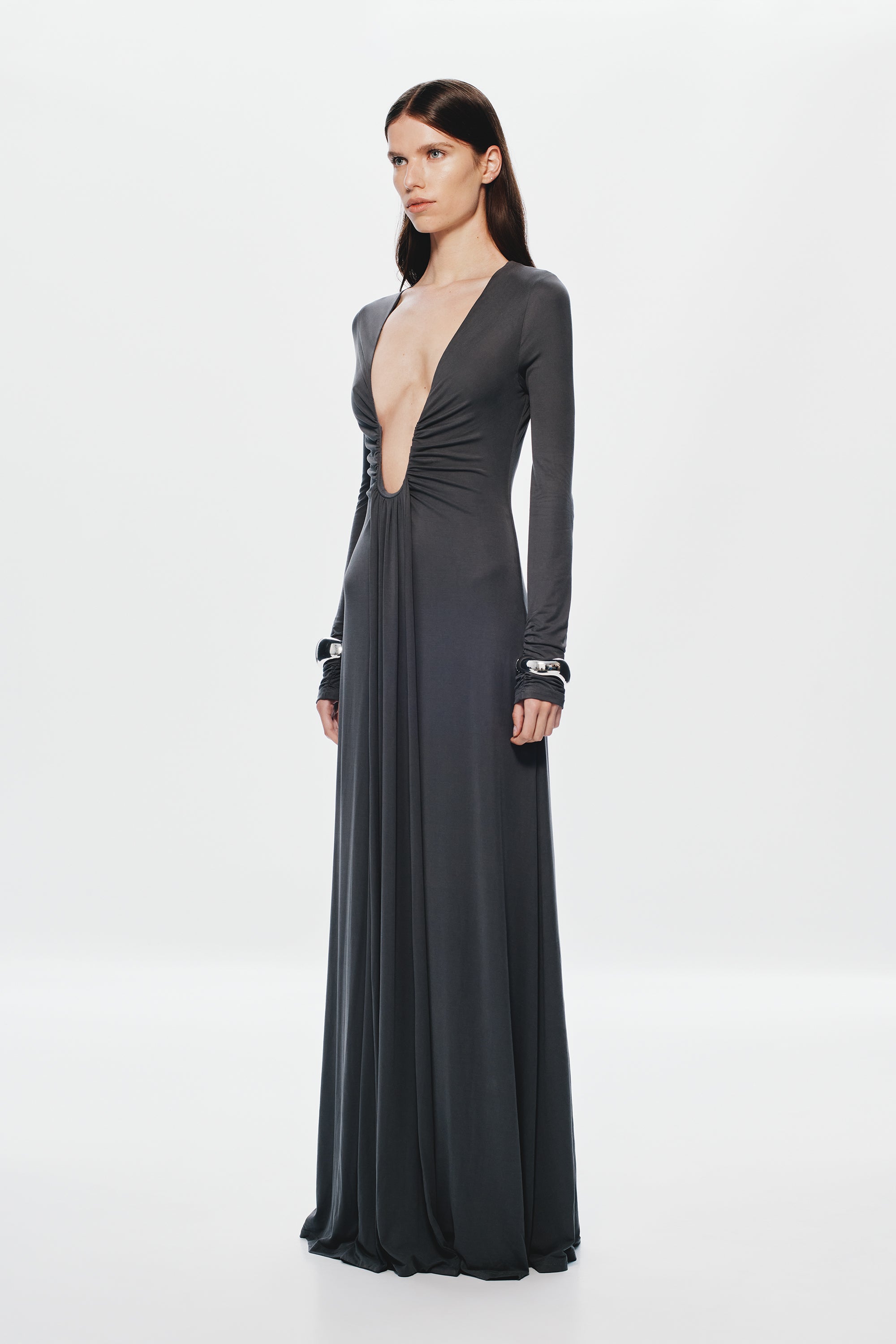 Dark long-sleeve maxi dress in a ruched deep-V front with long column skirt.
