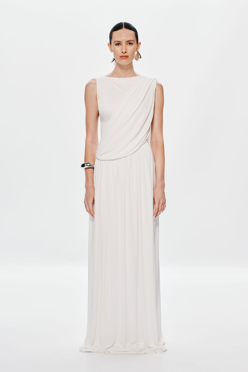 Ivory sleeveless maxi dress with draped bodice and pleated skirt