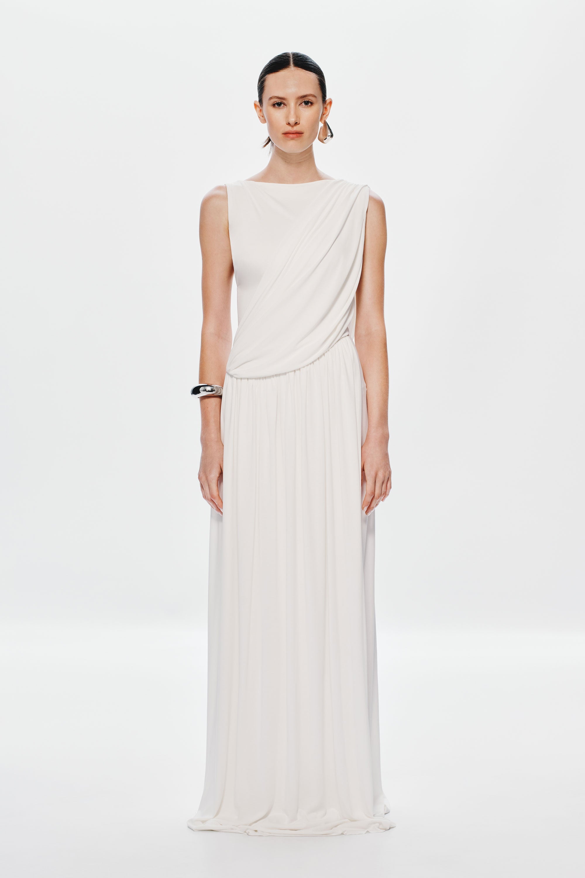 Ivory sleeveless maxi dress with draped bodice and pleated skirt