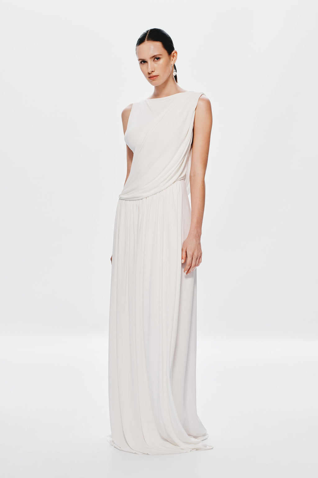 Ivory sleeveless maxi dress with diagonal drape front and pleated maxi skirt