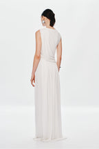 Ivory sleeveless maxi dress with draped back and gathered waist, pleated skirt