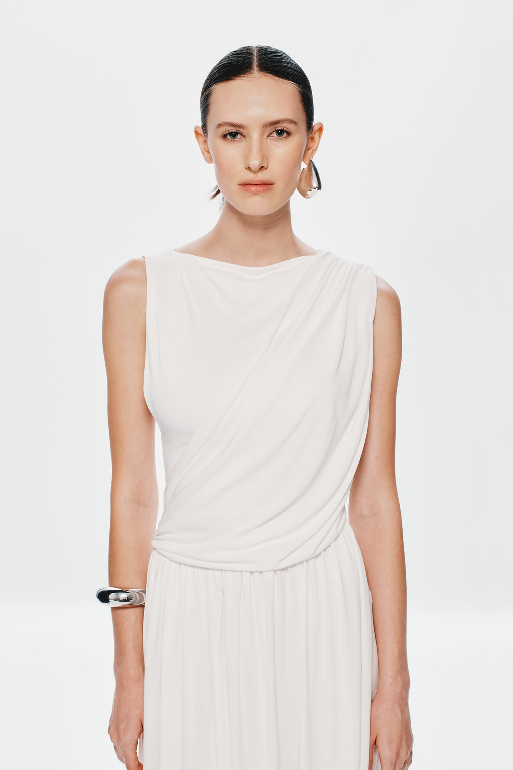 Ivory sleeveless maxi dress with draped bodice and gathered waist