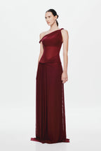 Maroon sleeveless one-shoulder maxi dress with draped waist and pleated sheer skirt