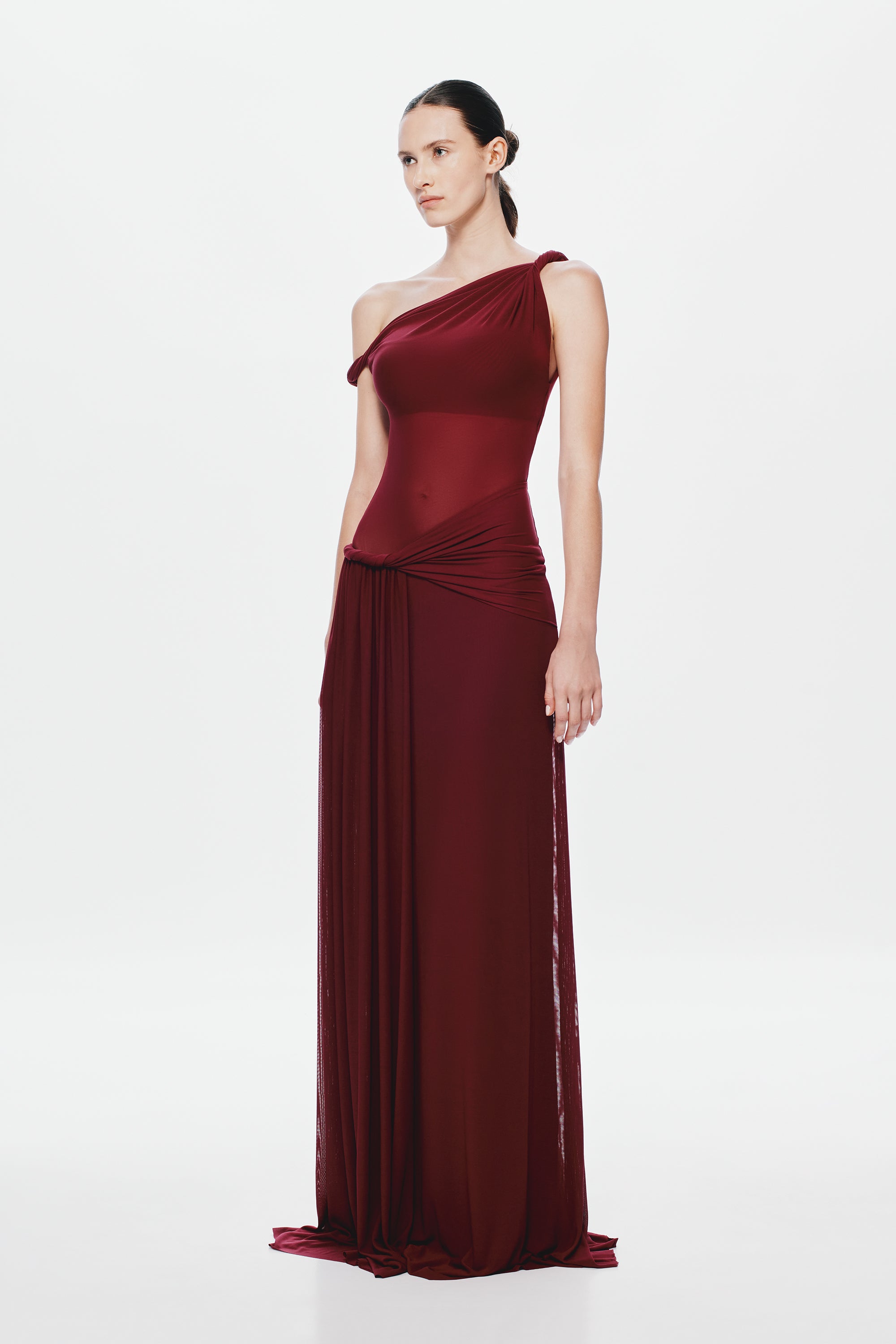 Maroon sleeveless one-shoulder maxi dress with draped waist and pleated sheer skirt