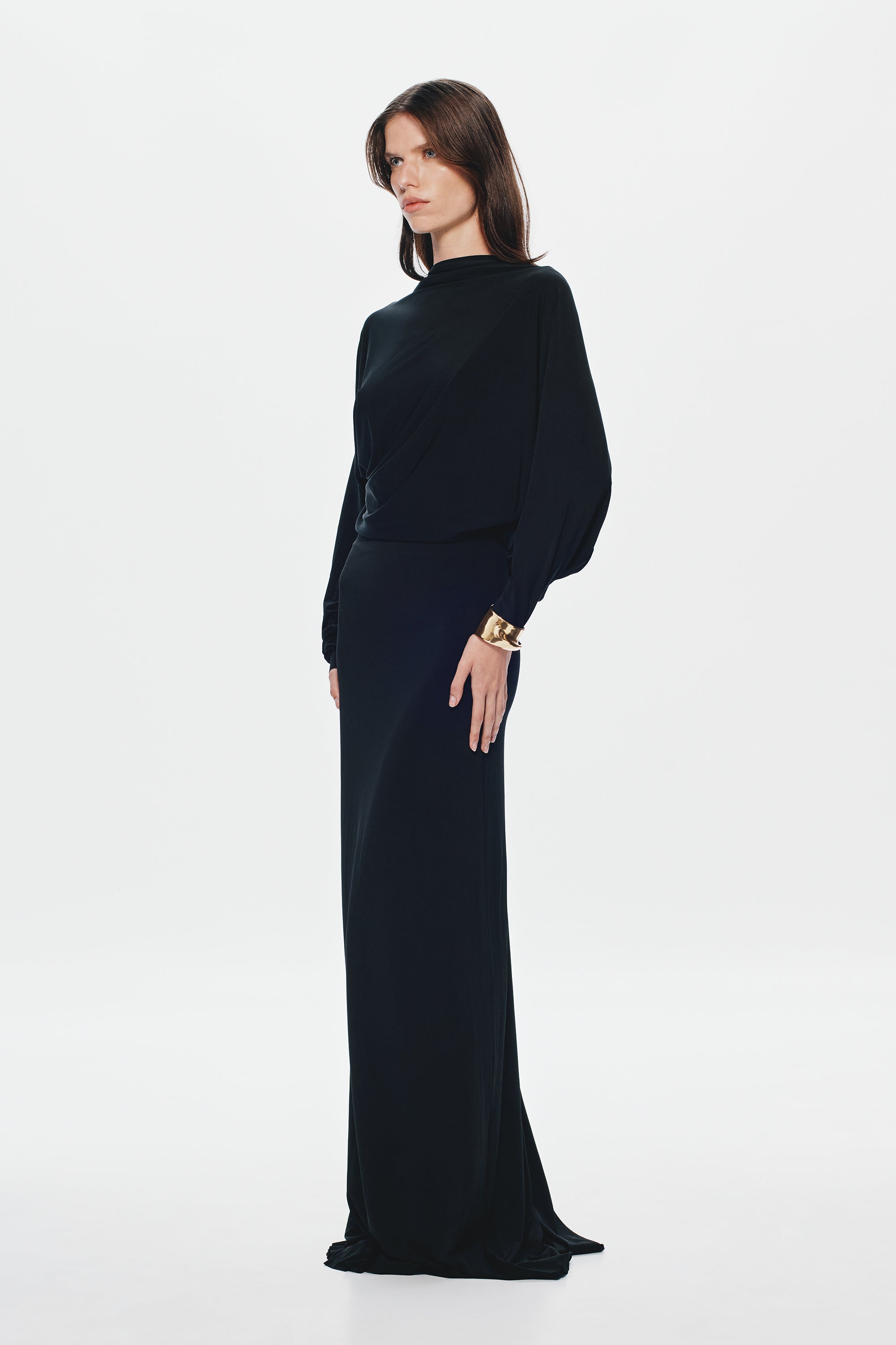 Black jersey maxi dress with high neck, long sleeves, waist belt