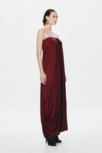 Burgundy strapless jersey maxi dress with gathered folds and draped cowl-like skirt