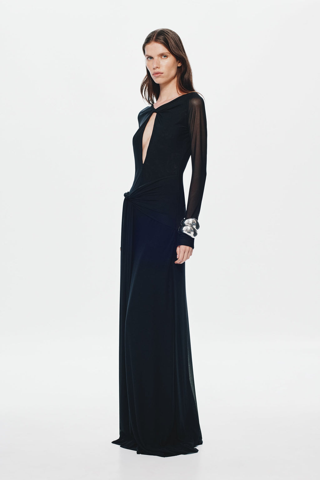 Black mesh maxi dress with long sleeves, fitted waist, and oval front cutout