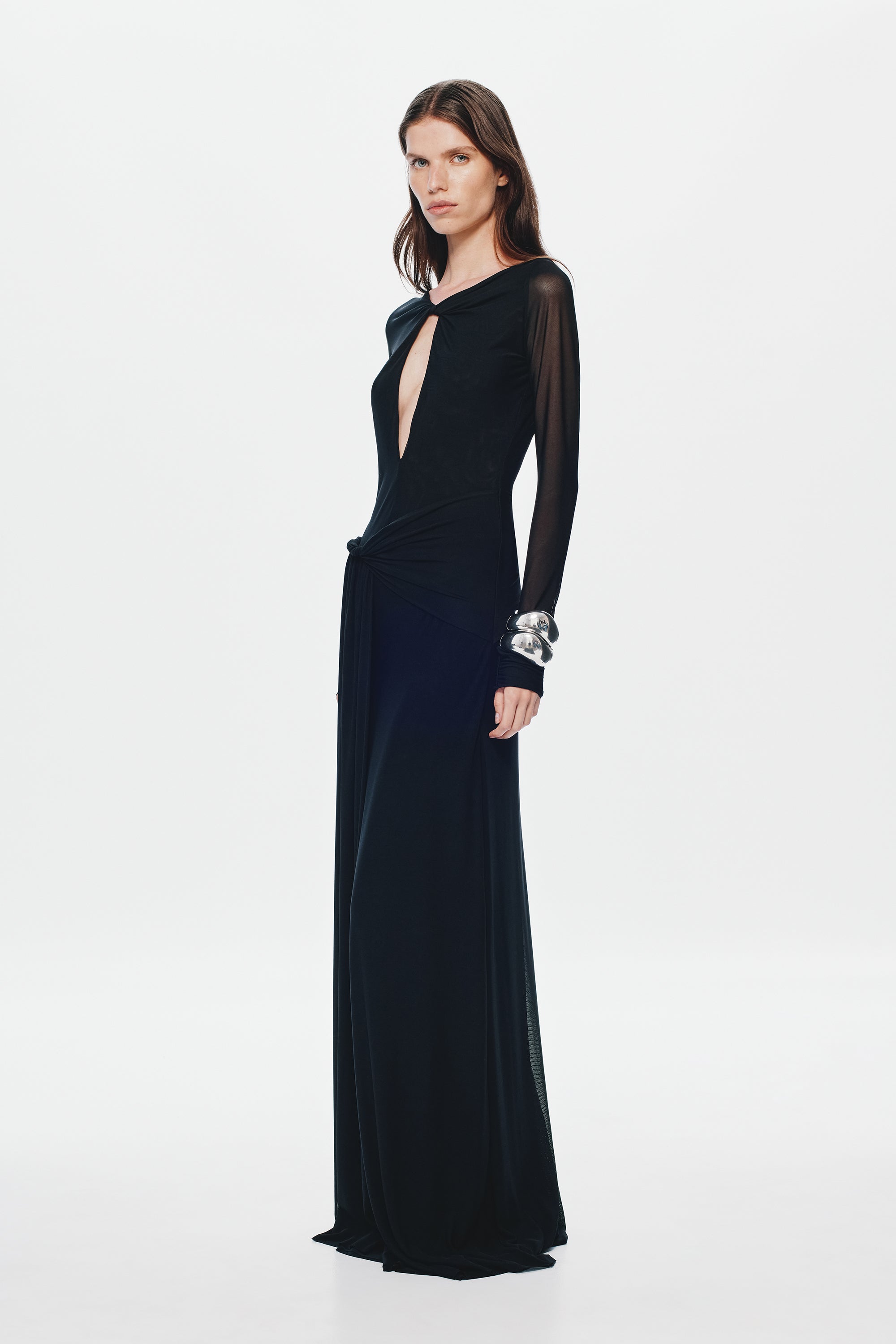 Black mesh maxi dress with long sleeves, fitted waist, and oval front cutout