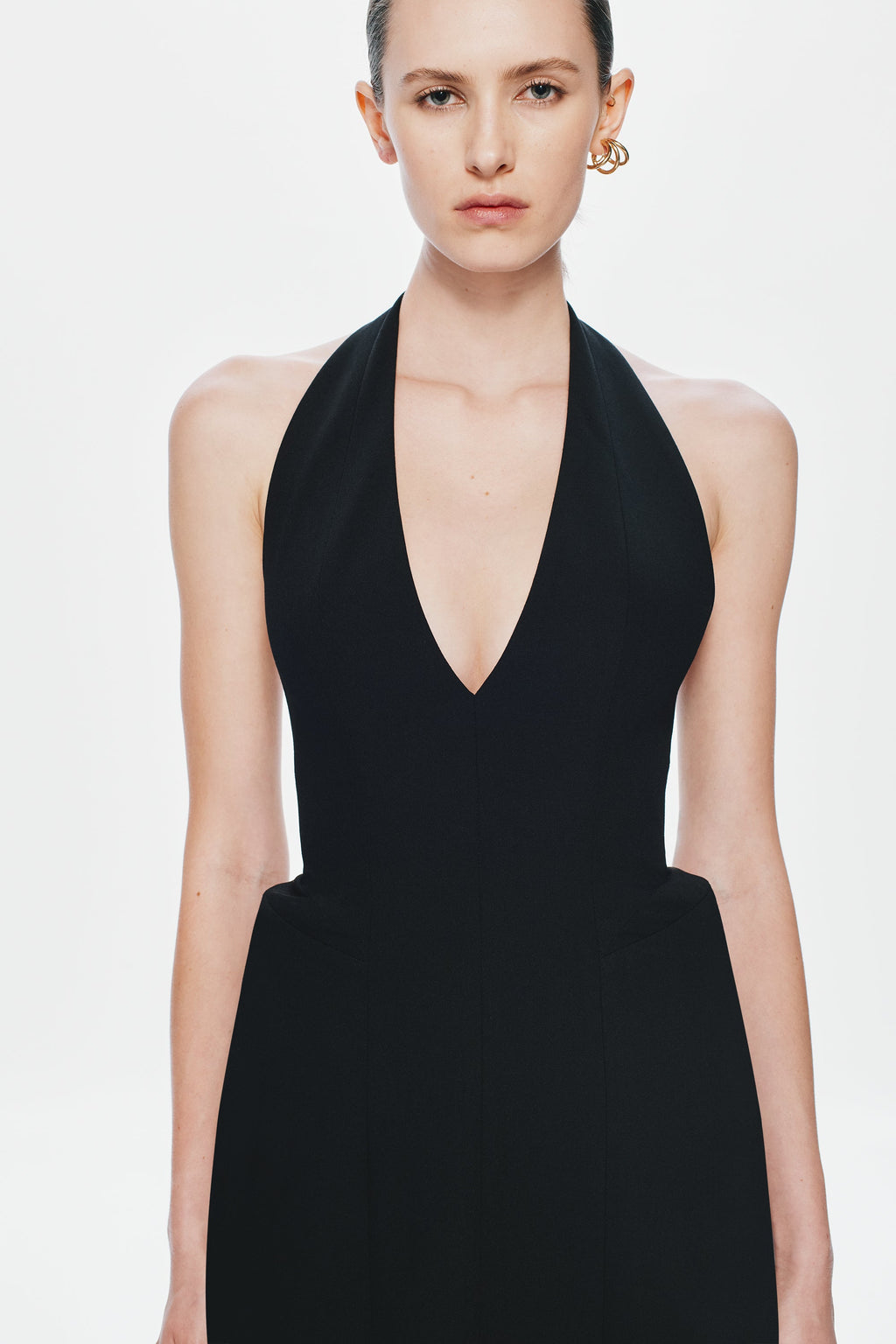 Black sleeveless suiting dress with deep V-neck front and fitted waist