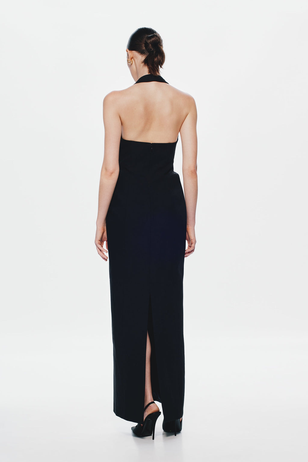 Back view of black sleeveless column suiting dress with open-back neckline