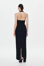 Back view of black sleeveless column suiting dress with open-back neckline