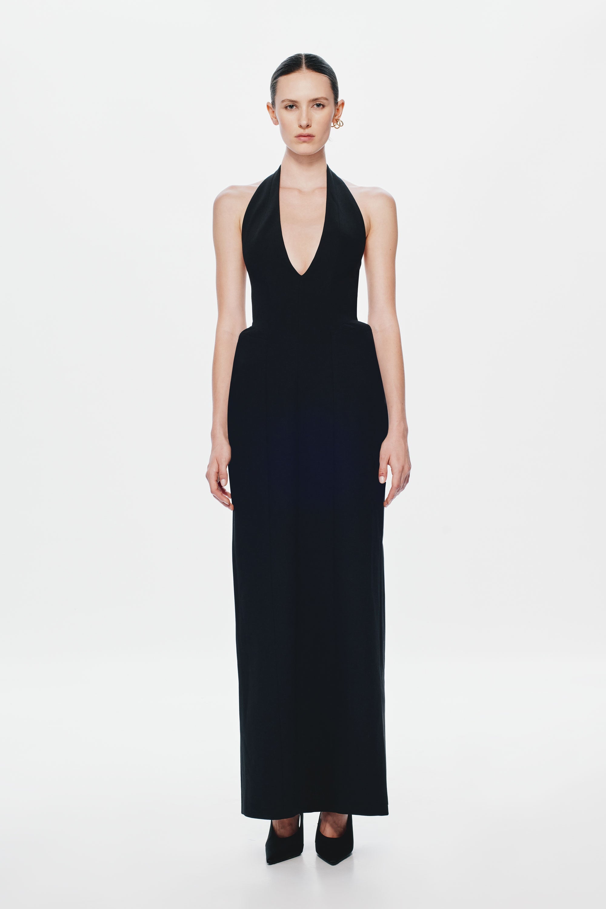 Black sleeveless halter suiting dress with deep V-neck and floor-length column fit
