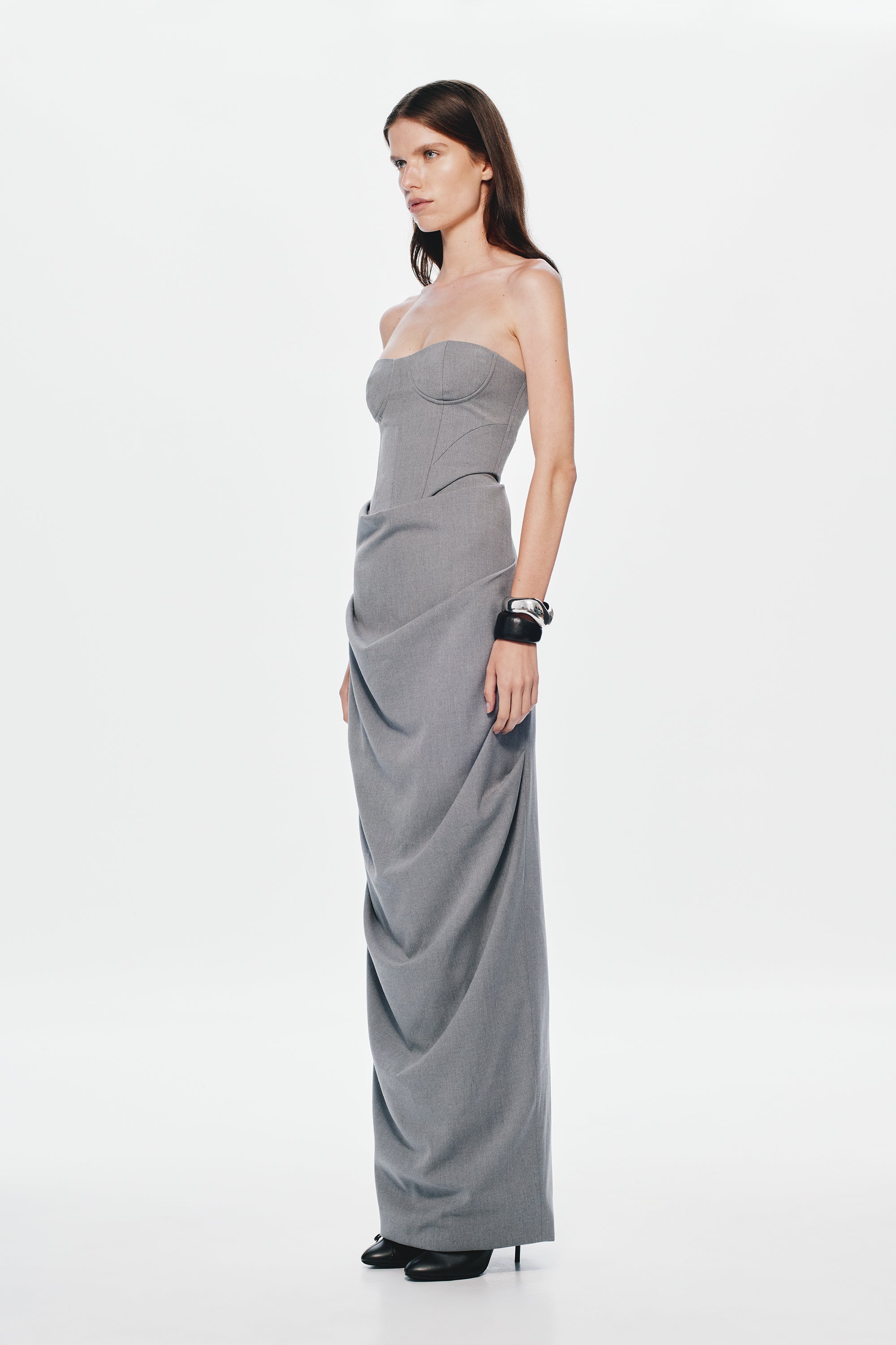 Grey strapless bustier with curved bust cups and draped longline fit