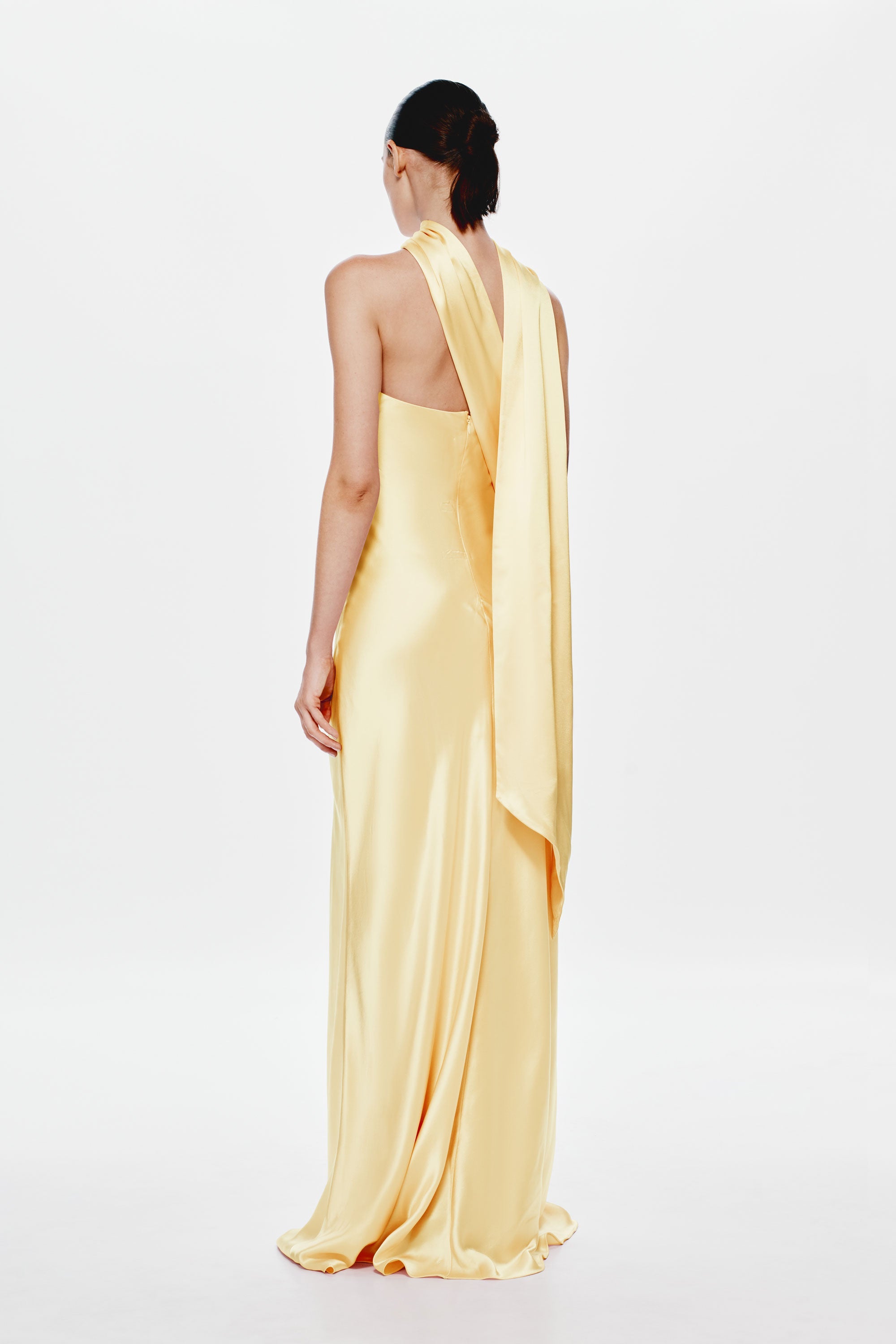 Soft yellow satin halter dress with draped back panel, long column silhouette