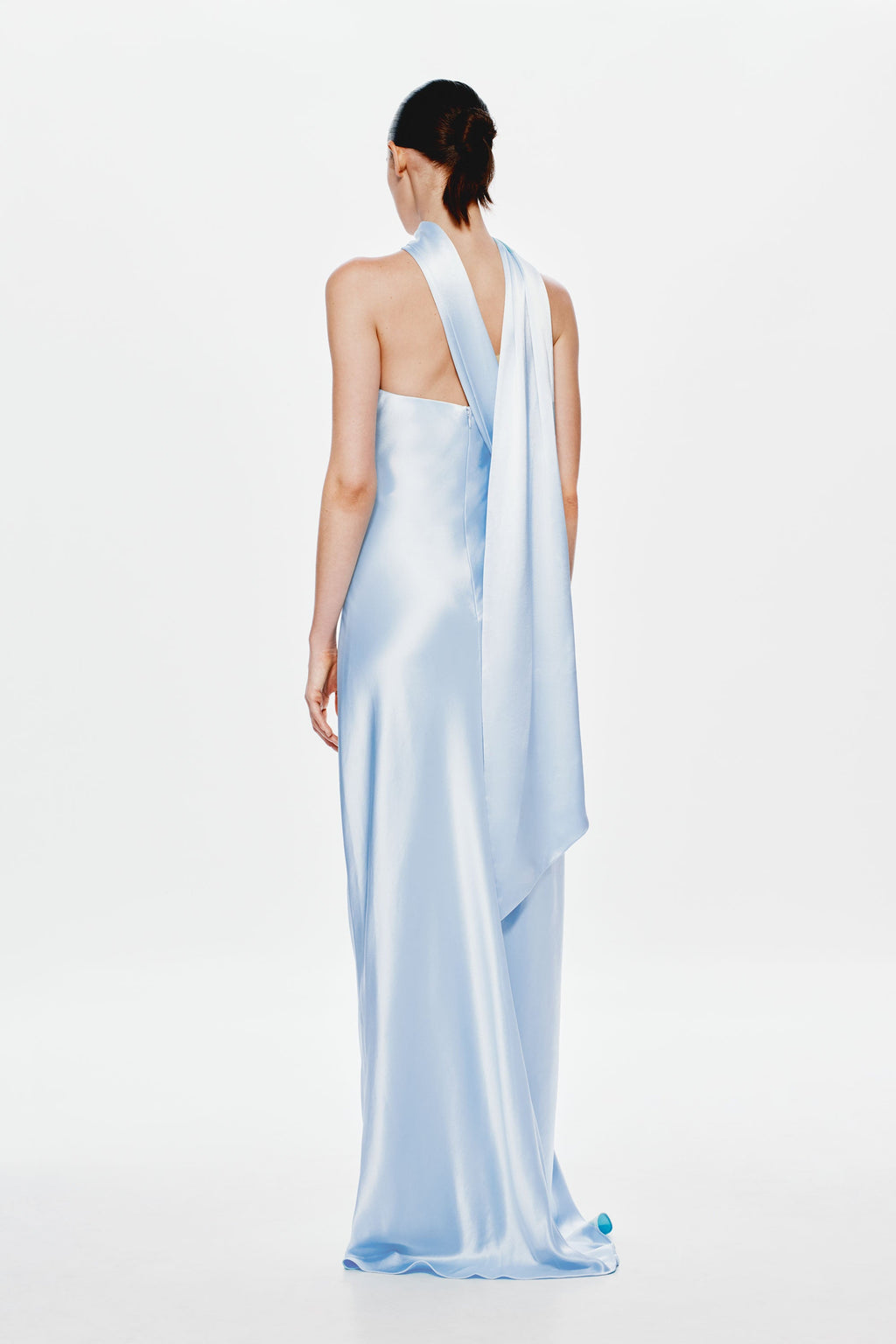 Light blue satin open-back maxi dress with halter strap and draped back panel.