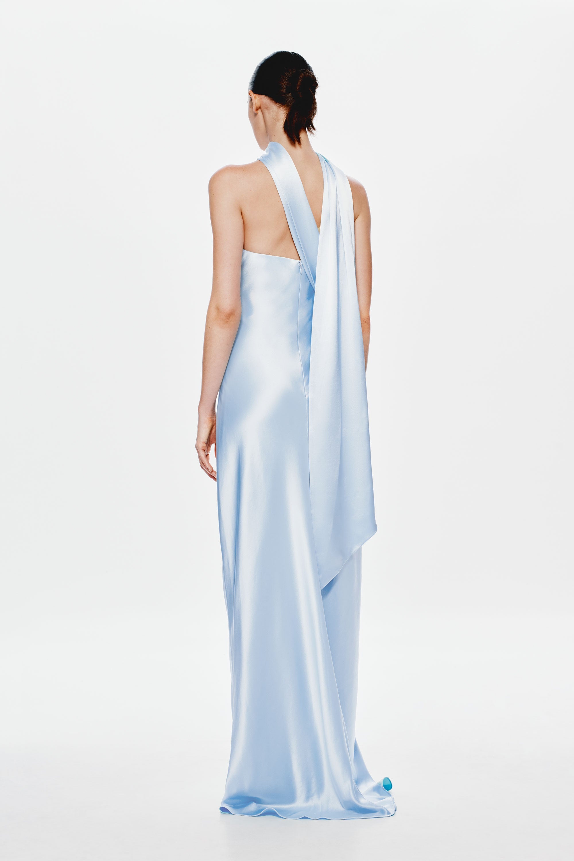 Light blue satin open-back maxi dress with halter strap and draped back panel.