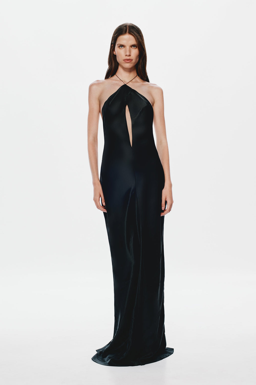 Black satin halter gown with center front slit-like opening and long column silhouette.