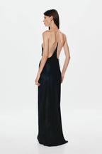 Black satin halter gown with open back, racerback straps, and floor-length column shape.