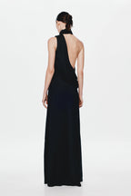 Back view of black satin sleeveless maxi dress with open back and draped neck