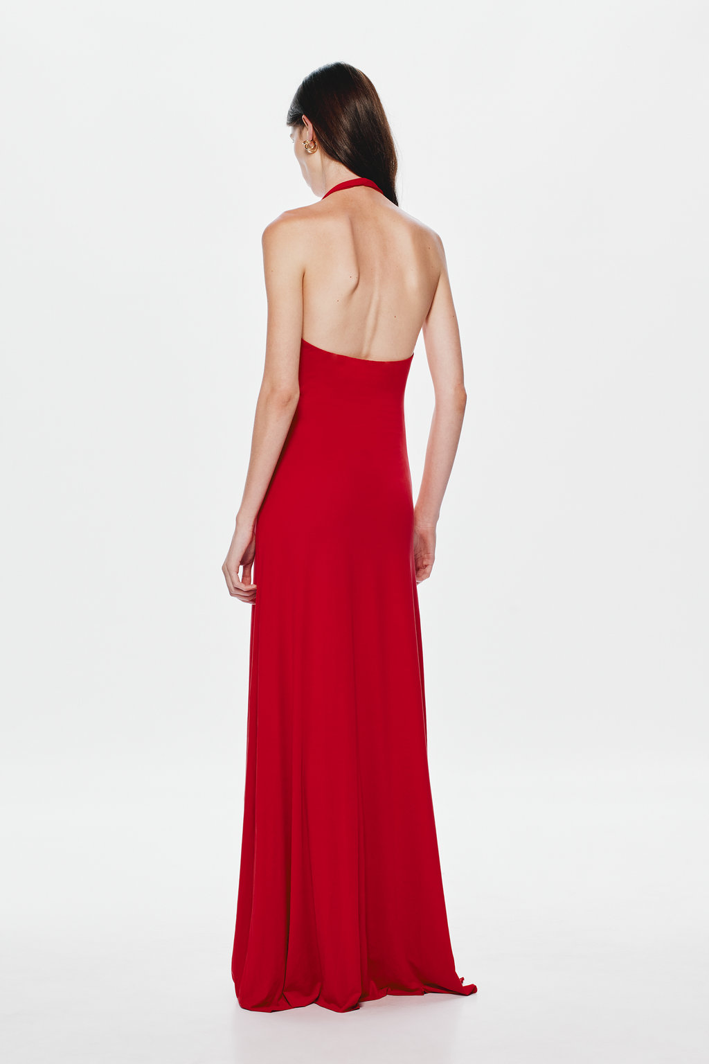 Back view of cherry red halter cupro dress with open back and long pleated skirt