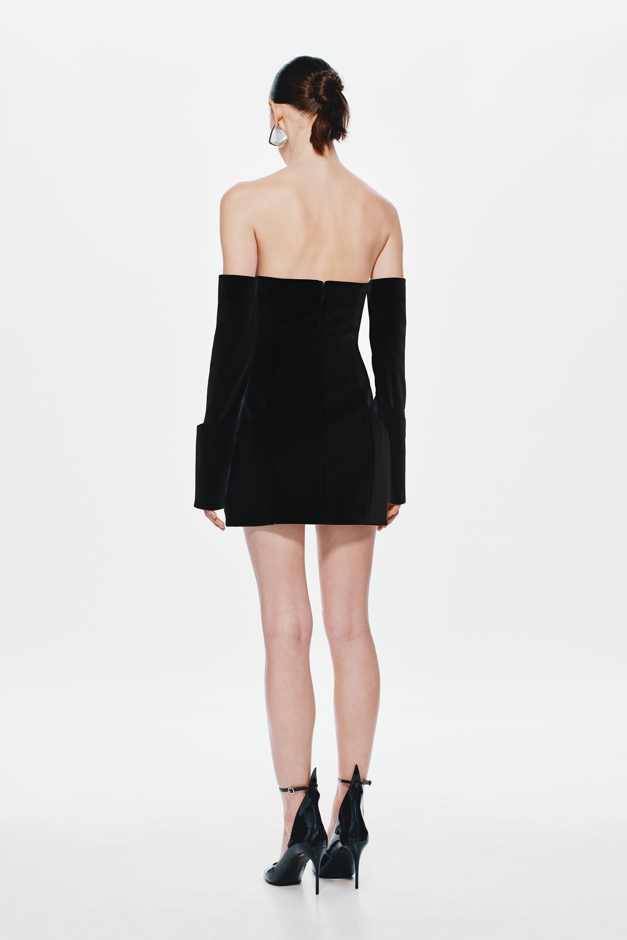 Black off-shoulder mini dress, long sleeves; back view with straight waist seam