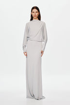 Grey jersey maxi dress with high neckline, long sleeves, and belted waist seam