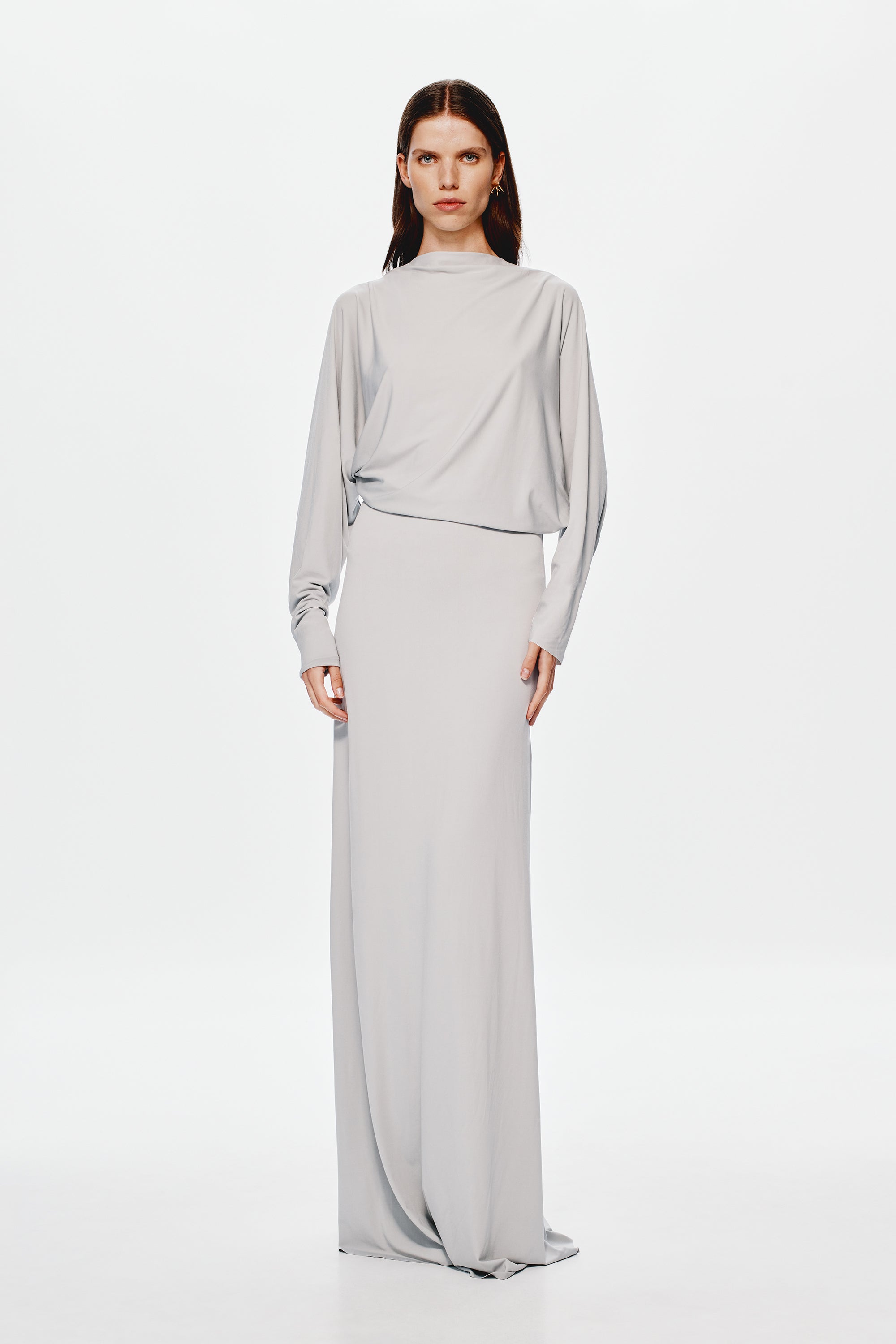 Grey jersey maxi dress with high neckline, long sleeves, and belted waist seam