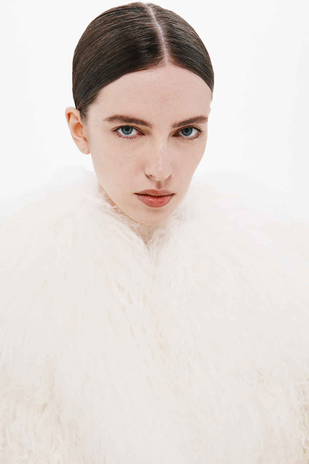 Ivory shearling coat collar and soft shaggy texture, close-up neckline