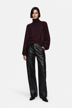 Black leather high-rise pants with belt loops and front crease seams
