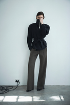 Black stand-collar acetate jacket with zip front and draped belted waist detail.