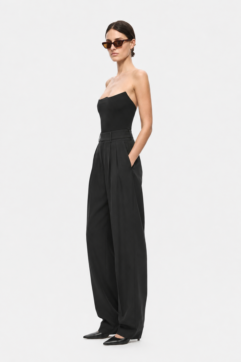 Black strapless jersey bodysuit front view with waist seam and subtle drape detail