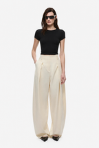 Cream wide-leg trousers with high waist and front pleat details