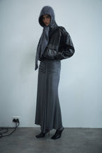 Dark charcoal cashmere hood worn over shoulders with wide, cozy drape