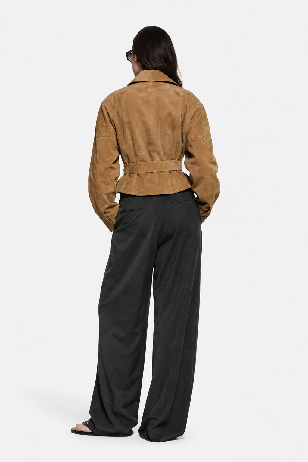 Back view of tan suede leather jacket with waist belt tie and long sleeves