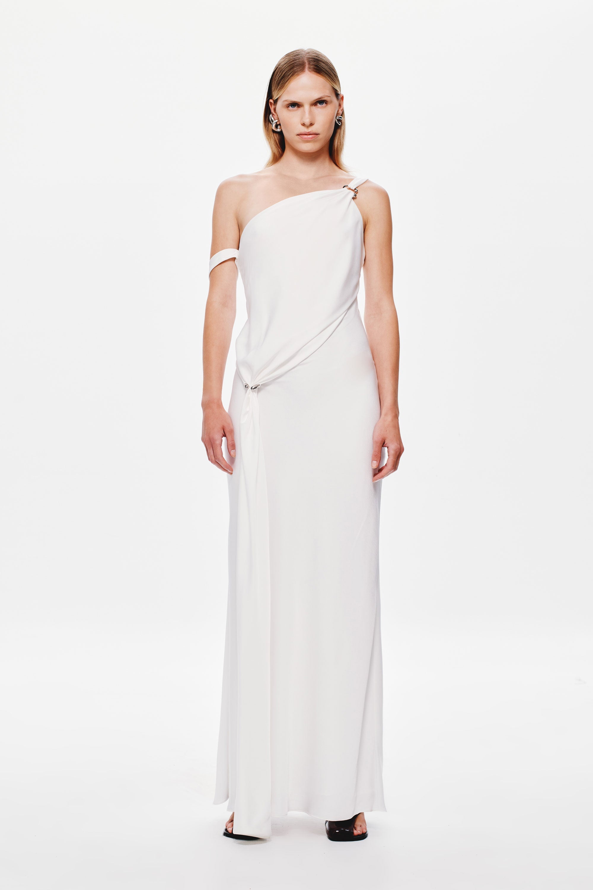 Ivory satin slip dress on model with off-shoulder neckline and diagonal drape