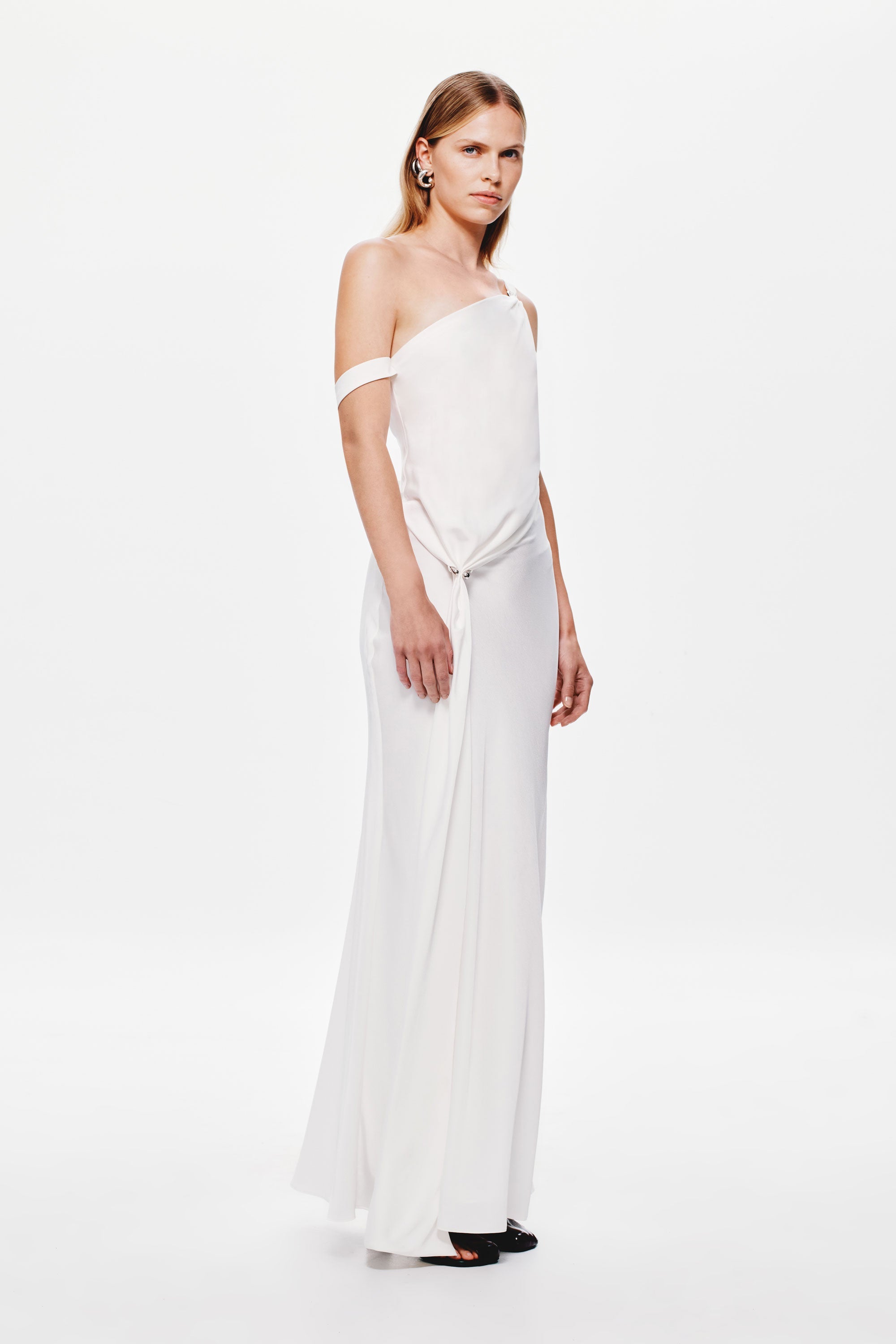 Ivory satin slip dress on model, one-shoulder style with draped front detail