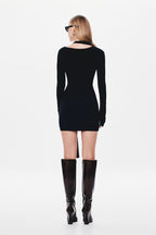Black jersey mini dress back view, long sleeves with asymmetrical lower split