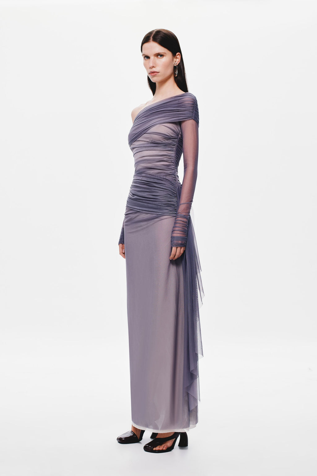 Off-shoulder mesh dress with asymmetric draped bodice, long column silhouette, sheer tulle overlay.