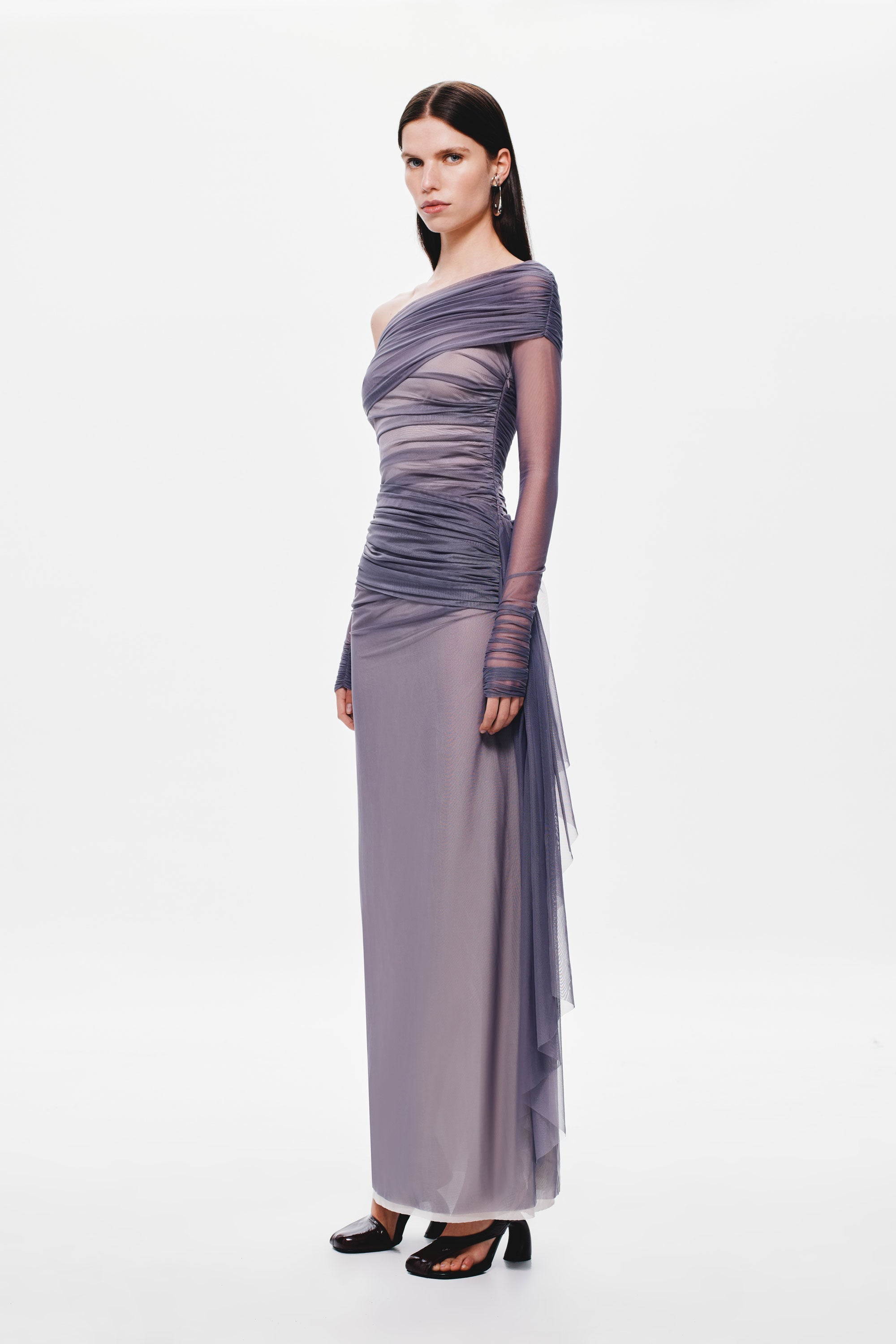 Off-shoulder mesh dress with asymmetric draped bodice, long column silhouette, sheer tulle overlay.