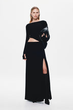 Black long-sleeve jersey maxi dress with waist cutout and thigh-high side slit