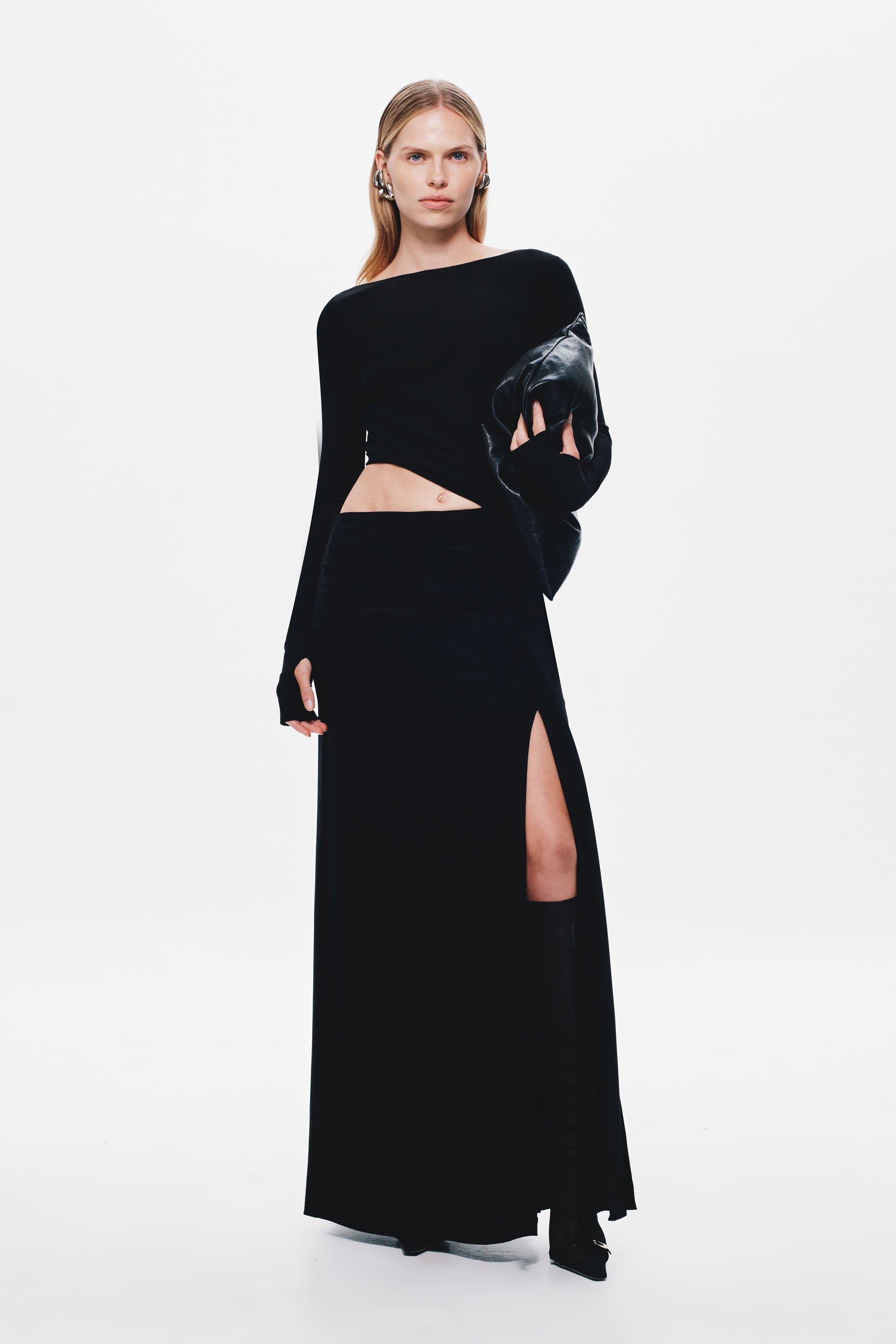 Black long-sleeve jersey maxi dress with waist cutout and thigh-high side slit