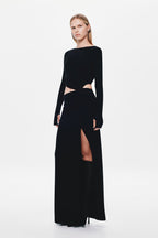 Black long-sleeve jersey maxi dress with off-center waist cutout and side slit