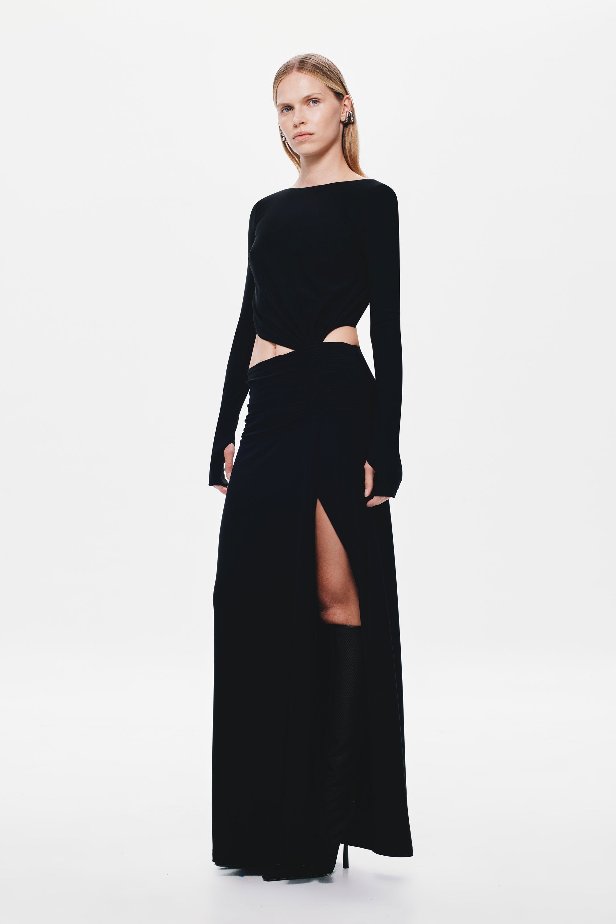 Black long-sleeve jersey maxi dress with off-center waist cutout and side slit